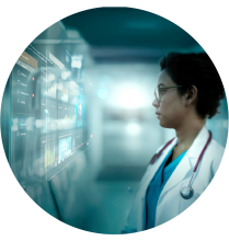 A women, professional healthcare worker, standing in front of medical equipment.
