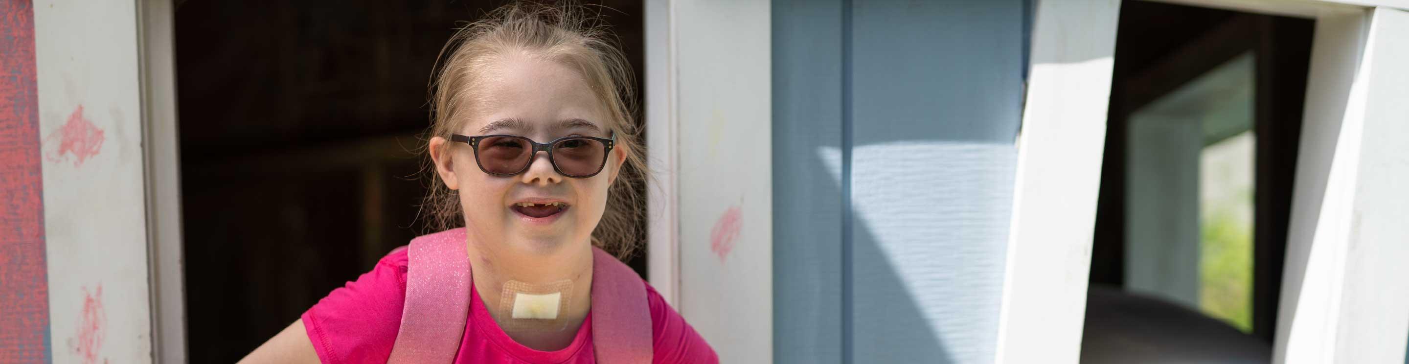 A young girl wearing glasses.