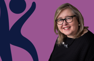 Jennifer Gillivan with glasses in black top against purple background with dark-blue abstract figure.